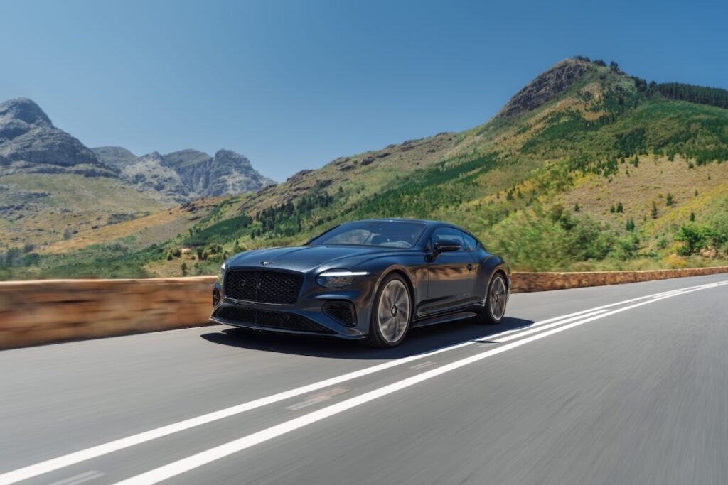 Bentley Continental GT S 2026 performance coupe driving on a winding mountain road.